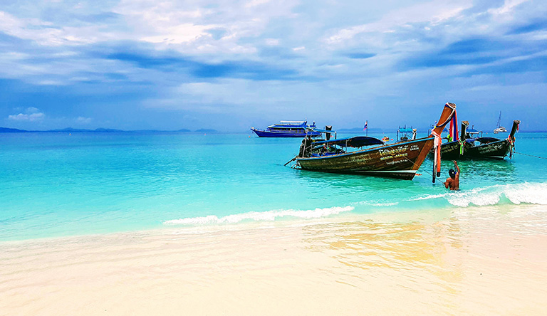 two-brown-boats-on-the-beach-phuket-thailand